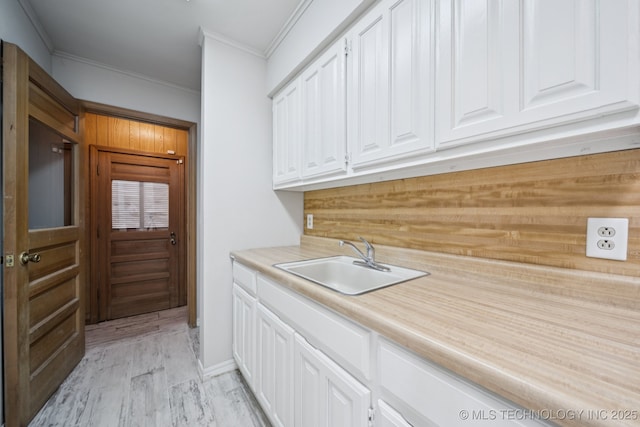 148 E 57th St, Tulsa, OK 74105 - washroom with crown molding and light wood-style floors