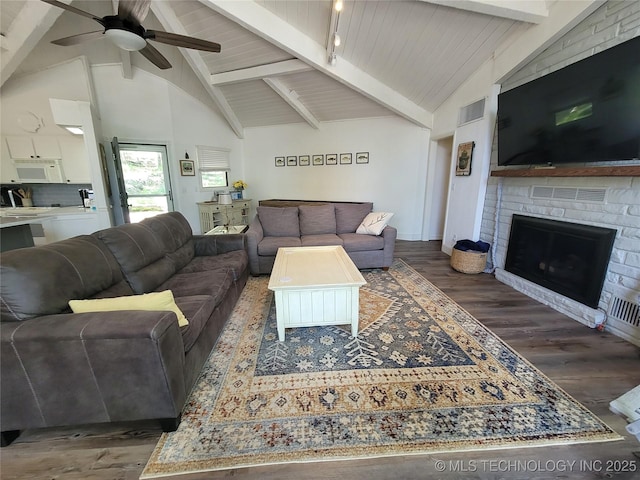 1416 Robin Hood Rd, Eufaula, OK 74432 - living area featuring a ceiling fan, wood finished floors, beam ceiling, a fireplace, and high vaulted ceiling