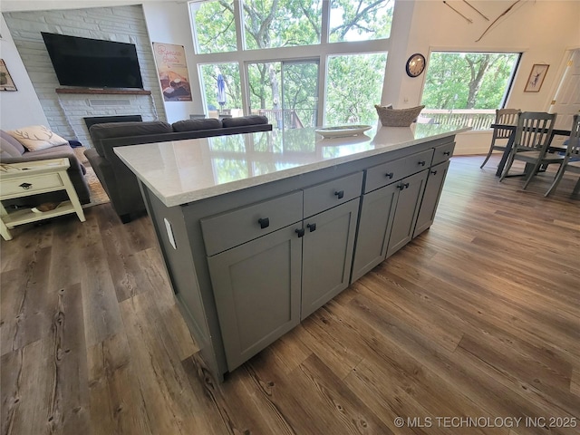 1416 Robin Hood Rd, Eufaula, OK 74432 - kitchen with gray cabinetry, light countertops, open floor plan, and a fireplace
