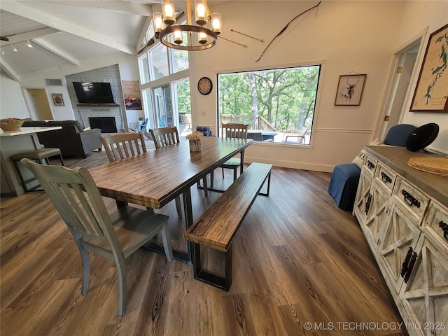 1416 Robin Hood Rd, Eufaula, OK 74432 - dining space with a chandelier, dark wood-type flooring, and a brick fireplace