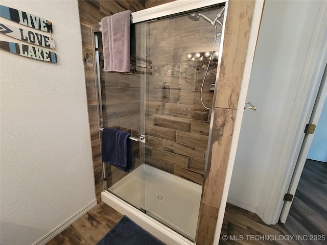 1416 Robin Hood Rd, Eufaula, OK 74432 - bathroom featuring a stall shower and wood finished floors
