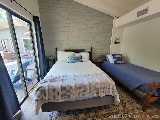 1416 Robin Hood Rd, Eufaula, OK 74432 - bedroom with wood finished floors, lofted ceiling, and access to outside