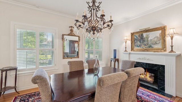 429 Kendall, Muskogee, OK 74401 - dining area featuring a chandelier, crown molding, wood finished floors, and a high end fireplace