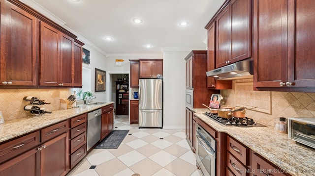 429 Kendall, Muskogee, OK 74401 - kitchen featuring appliances with stainless steel finishes, under cabinet range hood, light floors, crown molding, and light stone counters