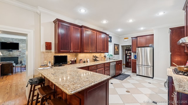 429 Kendall, Muskogee, OK 74401 - kitchen with appliances with stainless steel finishes, a peninsula, light stone countertops, a breakfast bar area, and tasteful backsplash