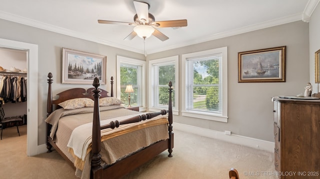 429 Kendall, Muskogee, OK 74401 - bedroom with light carpet, a spacious closet, ornamental molding, a closet, and a ceiling fan