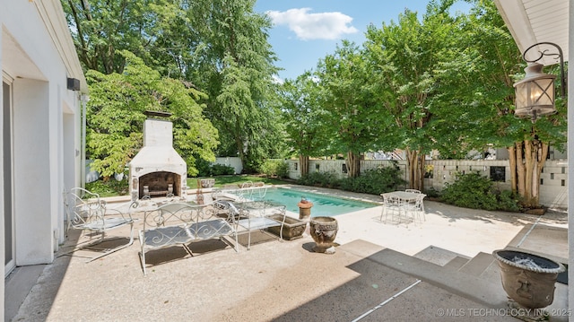 429 Kendall, Muskogee, OK 74401 - fenced backyard with an outdoor fireplace and a patio area
