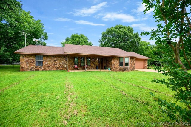 1001 E 1990th Rd, Soper, OK 74759 - rear view of house featuring stone siding, an attached garage, and a yard