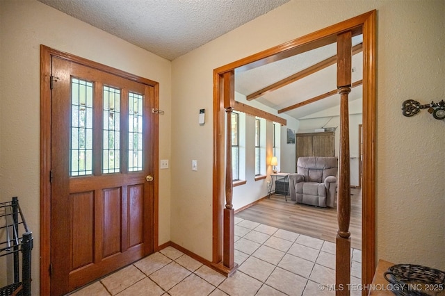1001 E 1990th Rd, Soper, OK 74759 - foyer with light tile patterned flooring, vaulted ceiling, a textured ceiling, and a textured wall