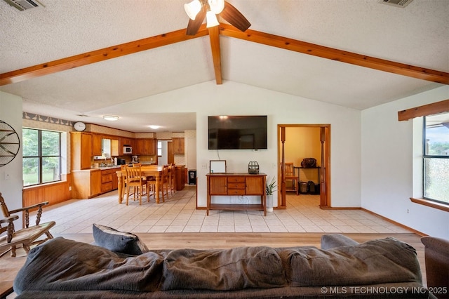 1001 E 1990th Rd, Soper, OK 74759 - living room with ceiling fan, a textured ceiling, and light tile patterned flooring