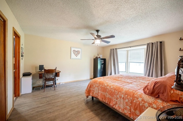 1001 E 1990th Rd, Soper, OK 74759 - bedroom with wood finished floors, a textured ceiling, and a ceiling fan