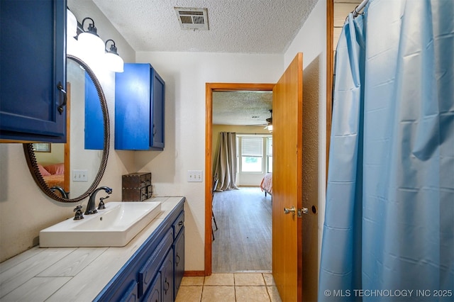 1001 E 1990th Rd, Soper, OK 74759 - ensuite bathroom featuring a textured ceiling, vanity, and a shower with curtain