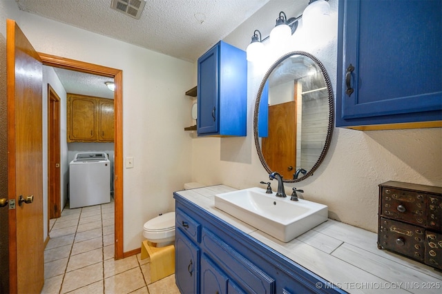 1001 E 1990th Rd, Soper, OK 74759 - bathroom with washer / clothes dryer, a textured ceiling, vanity, tile patterned floors, and a shower