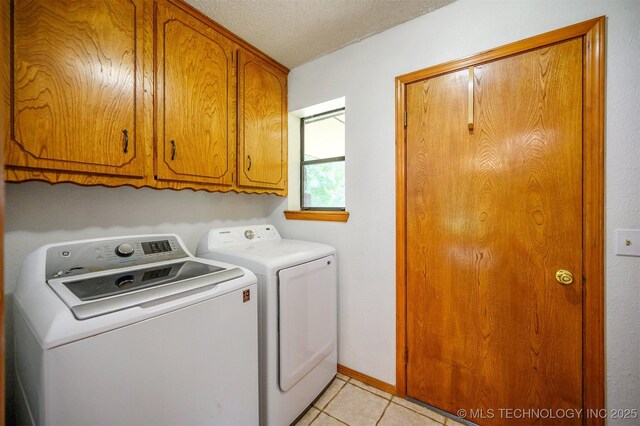 1001 E 1990th Rd, Soper, OK 74759 - laundry room with cabinet space, washer and clothes dryer, light tile patterned flooring, and a textured ceiling