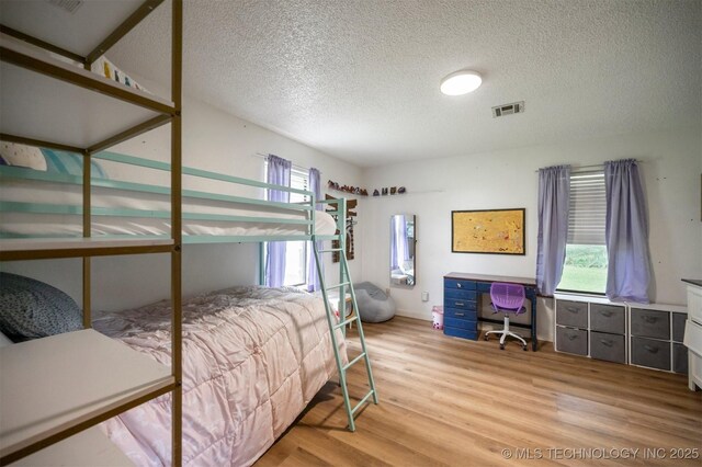 1001 E 1990th Rd, Soper, OK 74759 - bedroom featuring light wood finished floors and a textured ceiling