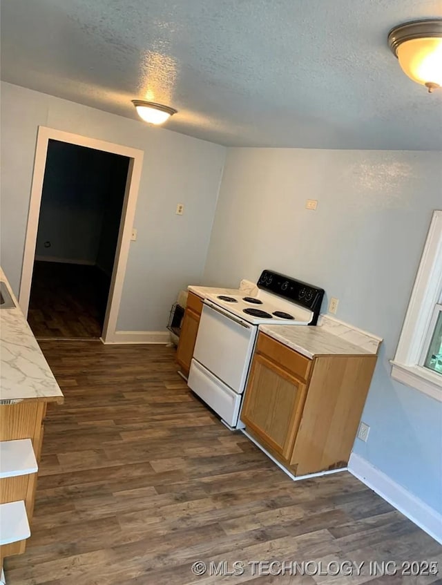 210 N G St, Muskogee, OK 74403 - kitchen with white electric stove, a textured ceiling, dark wood finished floors, and light countertops