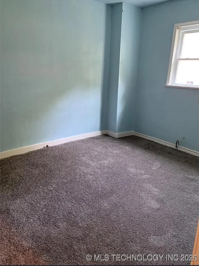210 N G St, Muskogee, OK 74403 - spare room with carpet