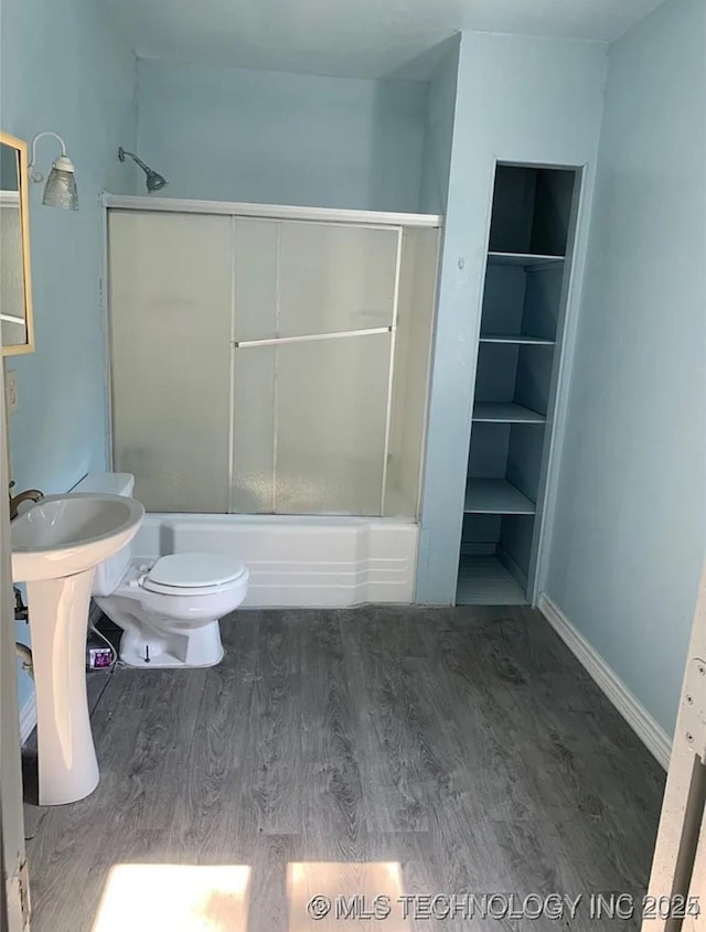 210 N G St, Muskogee, OK 74403 - full bath with wood finished floors and combined bath / shower with glass door