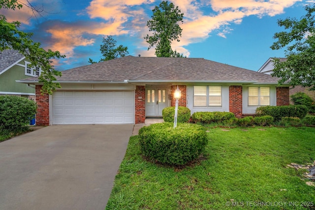 6725 E 51st Pl S, Tulsa, OK 74145 - ranch-style house featuring a garage, concrete driveway, brick siding, a lawn, and roof with shingles