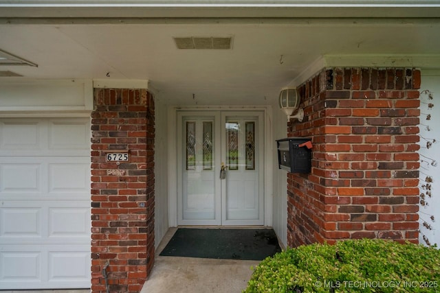 6725 E 51st Pl S, Tulsa, OK 74145 - entrance to property with brick siding, french doors, and a garage