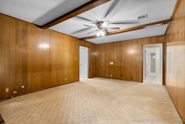 6725 E 51st Pl S, Tulsa, OK 74145 - spare room featuring beam ceiling, wooden walls, ceiling fan, and light carpet