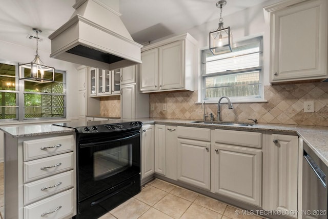 6725 E 51st Pl S, Tulsa, OK 74145 - kitchen with black electric range oven, premium range hood, stainless steel dishwasher, light tile patterned flooring, and decorative backsplash