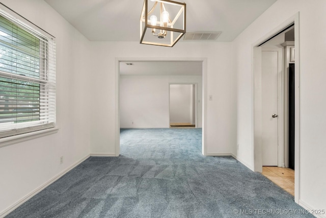 6725 E 51st Pl S, Tulsa, OK 74145 - hallway featuring carpet and a chandelier