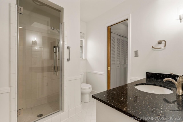 6725 E 51st Pl S, Tulsa, OK 74145 - full bath with vanity, a shower stall, wainscoting, a closet, and tile patterned floors