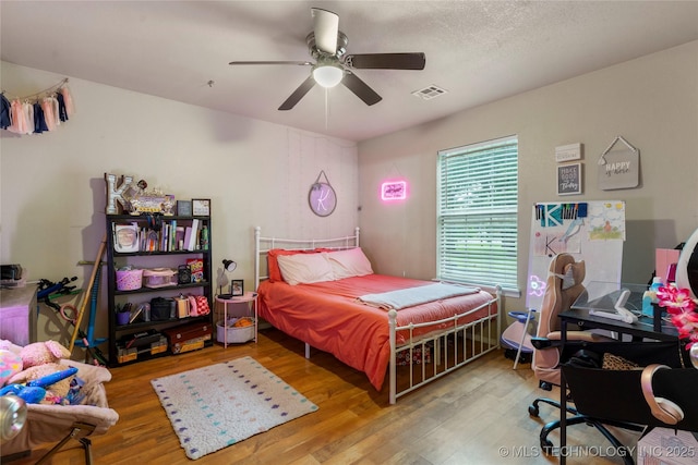 704 NE 3rd St, Wagoner, OK 74467 - bedroom with wood finished floors and ceiling fan