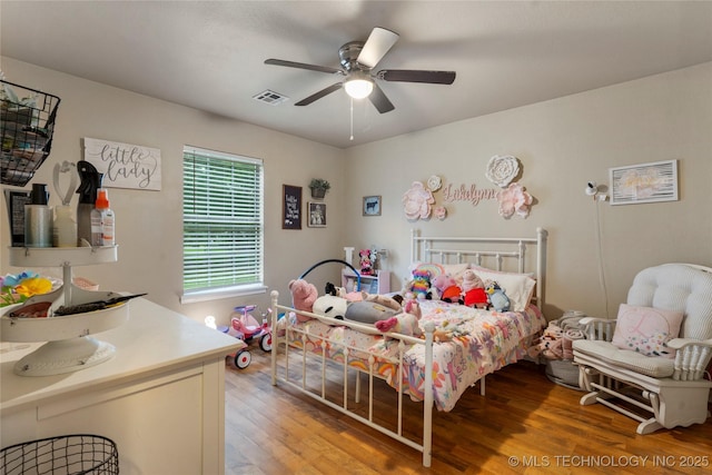 704 NE 3rd St, Wagoner, OK 74467 - bedroom with light wood finished floors and ceiling fan