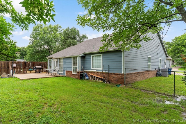 704 NE 3rd St, Wagoner, OK 74467 - back of house featuring a fenced backyard, brick siding, and a patio