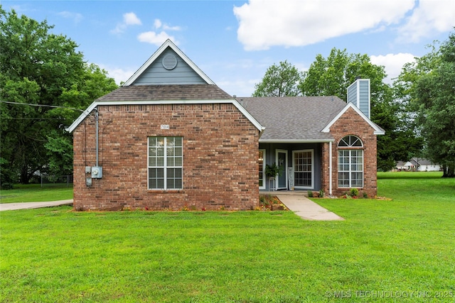 704 NE 3rd St, Wagoner, OK 74467 - view of front facade featuring roof with shingles, a chimney, a front yard, and brick siding