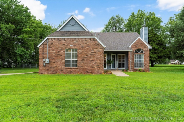 704 NE 3rd St, Wagoner, OK 74467 - view of front of house with roof with shingles, a chimney, and brick siding