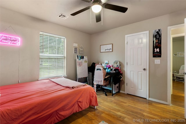 704 NE 3rd St, Wagoner, OK 74467 - bedroom with light wood-type flooring and ceiling fan