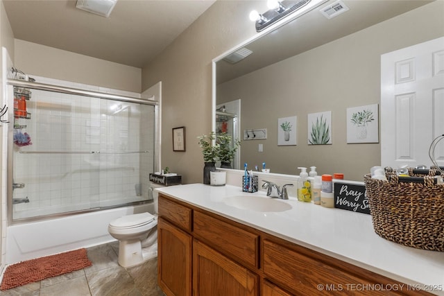 704 NE 3rd St, Wagoner, OK 74467 - bathroom with vanity, bath / shower combo with glass door, and tile patterned flooring