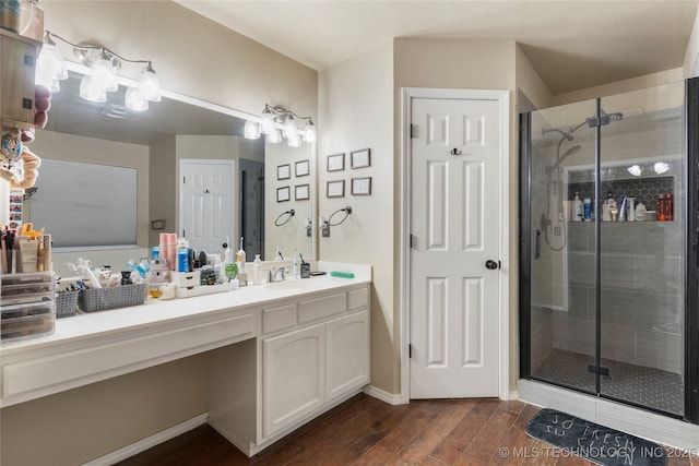 704 NE 3rd St, Wagoner, OK 74467 - bathroom with wood finished floors, vanity, and a stall shower
