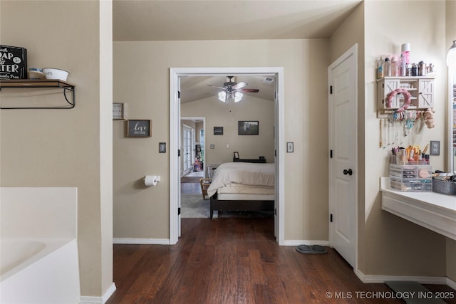 704 NE 3rd St, Wagoner, OK 74467 - corridor featuring dark wood-style flooring and vaulted ceiling