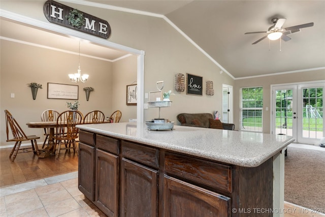 704 NE 3rd St, Wagoner, OK 74467 - kitchen with vaulted ceiling, open floor plan, crown molding, pendant lighting, and dark brown cabinets