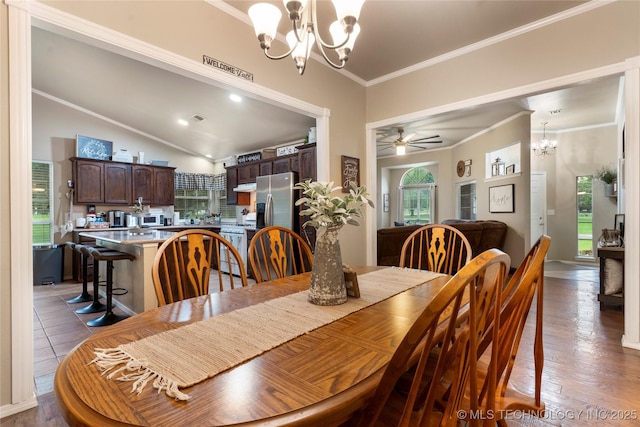 704 NE 3rd St, Wagoner, OK 74467 - dining room featuring a chandelier, ornamental molding, ceiling fan, light wood-type flooring, and lofted ceiling