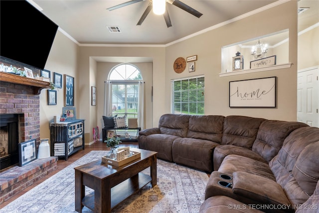 704 NE 3rd St, Wagoner, OK 74467 - living area with ornamental molding, a ceiling fan, a chandelier, wood finished floors, and a fireplace