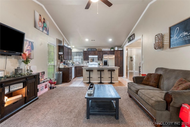 704 NE 3rd St, Wagoner, OK 74467 - living room featuring vaulted ceiling, a ceiling fan, and recessed lighting