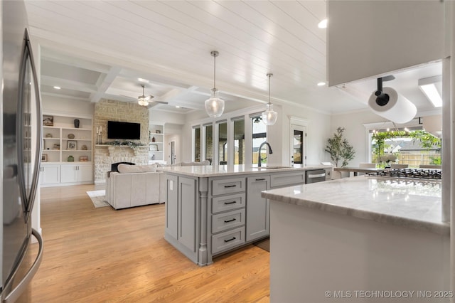 17831 S 46th E Ave, Bixby, OK 74008 - kitchen featuring gray cabinets, appliances with stainless steel finishes, ceiling fan, a stone fireplace, and open floor plan