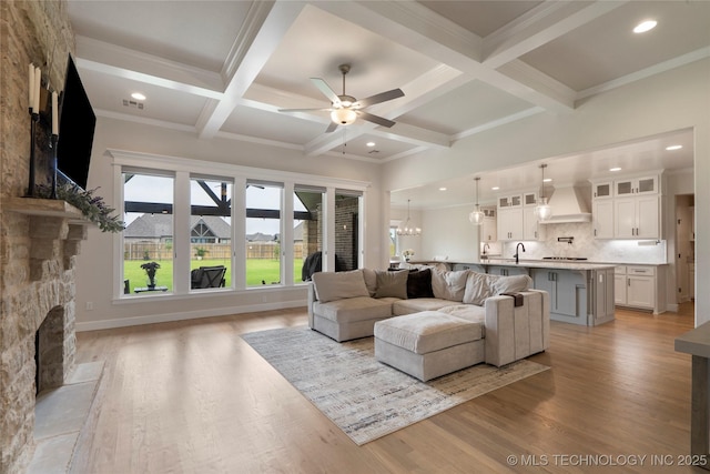 17831 S 46th E Ave, Bixby, OK 74008 - living room featuring a stone fireplace, ceiling fan, beam ceiling, light wood finished floors, and recessed lighting