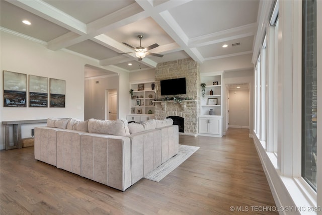 17831 S 46th E Ave, Bixby, OK 74008 - living room featuring light wood-style flooring, beamed ceiling, a ceiling fan, a fireplace, and coffered ceiling