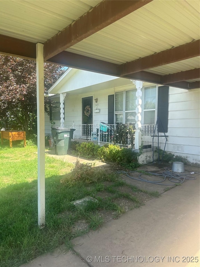 320 E Mckinley Ave, Sapulpa, OK 74066 - doorway to property featuring covered porch and a yard