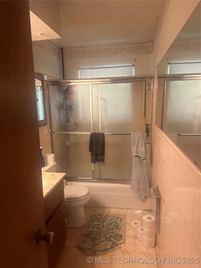 320 E Mckinley Ave, Sapulpa, OK 74066 - bathroom featuring vanity, shower / bath combination with glass door, and tile patterned floors