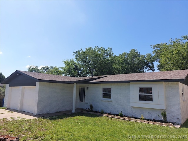 12623 E 19th St, Tulsa, OK 74128 - single story home featuring brick siding, a front lawn, an attached garage, and driveway