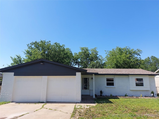 12623 E 19th St, Tulsa, OK 74128 - ranch-style home with brick siding, driveway, an attached garage, and a front lawn