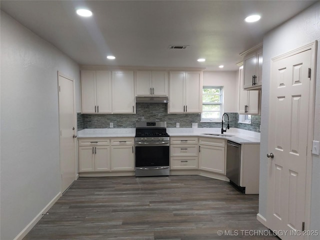12623 E 19th St, Tulsa, OK 74128 - kitchen featuring appliances with stainless steel finishes, decorative backsplash, light countertops, dark wood-style floors, and recessed lighting