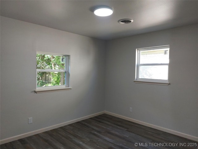 12623 E 19th St, Tulsa, OK 74128 - unfurnished room featuring plenty of natural light and dark wood-style flooring